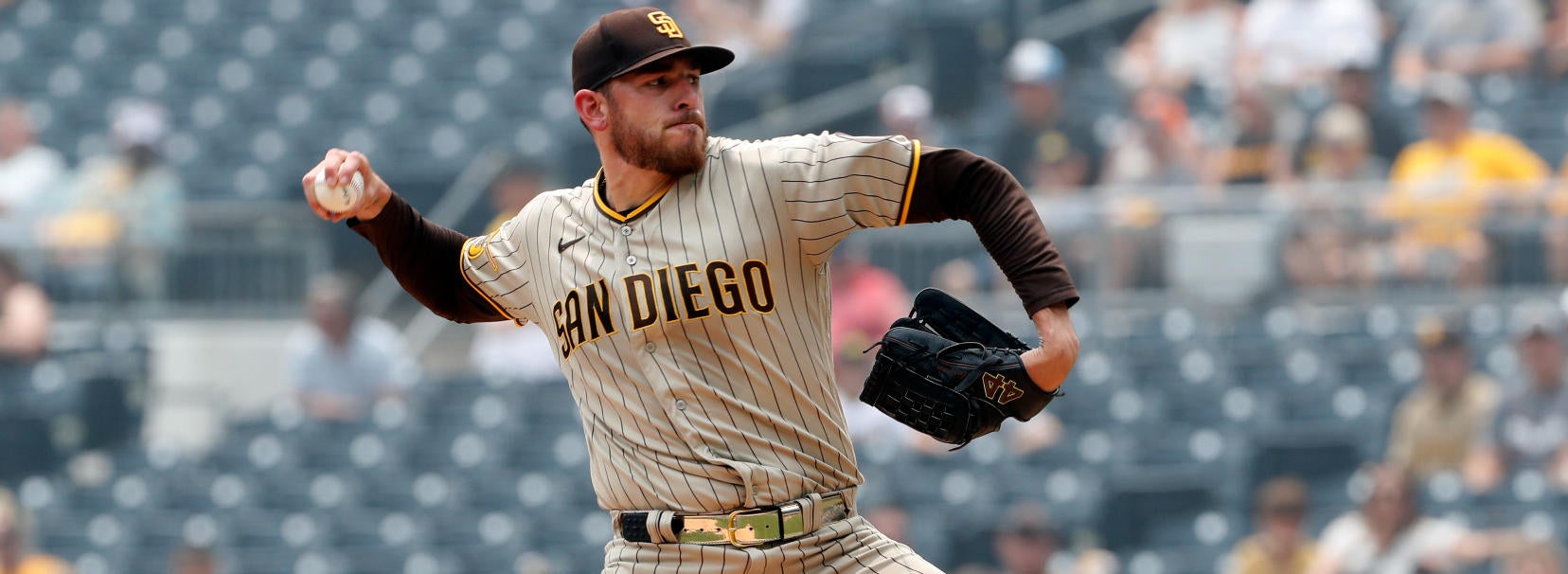 San Diego Padres' Joe Musgrove takes the field in a San Diego State  basketball jersey during warmups before a baseball game against the  Colorado Rockies in San Diego, Friday, March 31, 2023. (