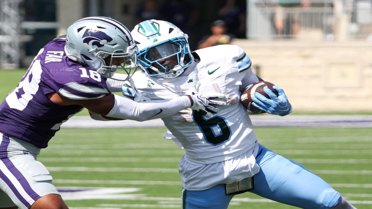 <p>Tulane Green Wave running back Johnnie Daniels (6) tries to get away from Kansas State Wildcats safety Wesley Fair (18) during the fourth quarter at Bill Snyder Family Football Stadium.&nbsp;</p>